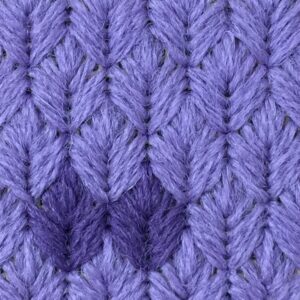 Close-up of purple knitted wool with diagonal ribbing and chunky yarn stitches.