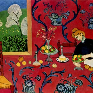 Woman in a white apron stands at a red-draped table, arranging fruit beside a cake in a colorful room with a floral wallpaper and a window showing greenery.